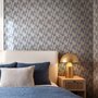 Cream colored wallpaper with denim blue geometric totem stripe repeat on a linen texture ground