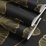 Black wallpaper with antique metallic gold ginkgo leaves on a mottled charcoal ground