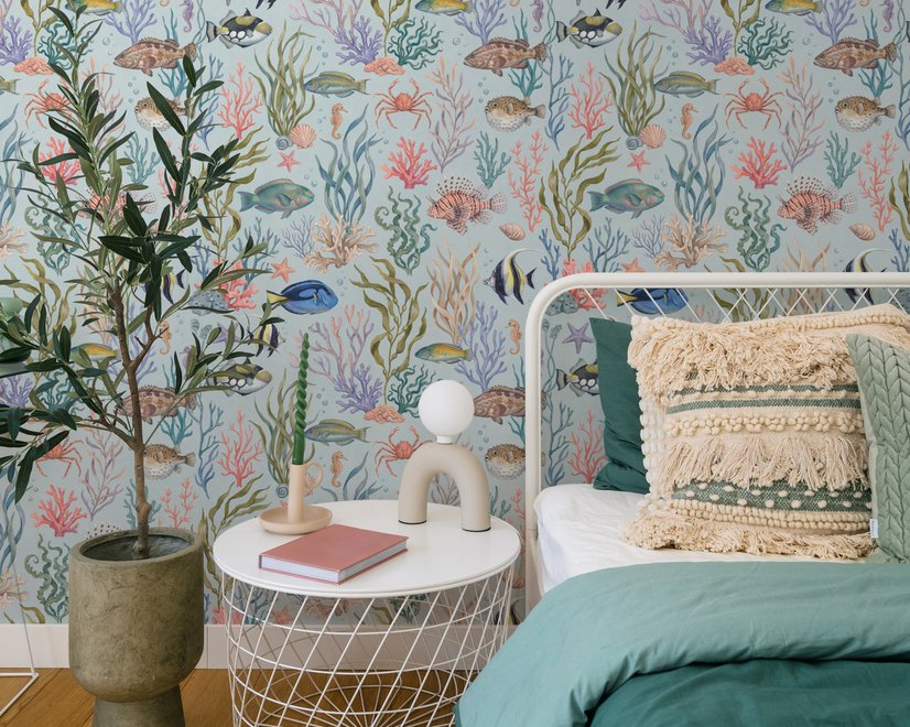 Modern coastal wallpaper with watercolour tropical fish, coral, seaweed, shells and bubbles on light aqua-blue