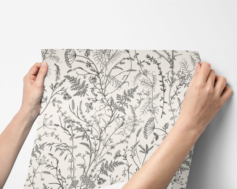 Black outline botanical wallpaper with charcoal wildflowers and grasses on a warm ivory cream ground
