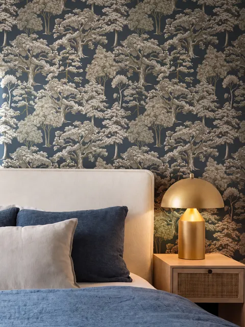 Navy wallpaper with warm ivory and taupe grey toile tree repeat on deep slate blue ground