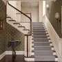 Black wallpaper with gold vertical chain link Art Deco repeat on a textured charcoal ground