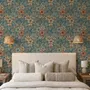 Blue tropical wallpaper with hibiscus, orchids, lilies, monstera leaves and palm fronds on a deep teal-blue ground