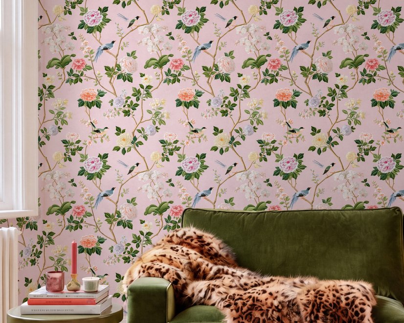 Cute pink wallpaper with birds, tan branches, green leaves and ivory, coral and lilac flowers.