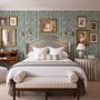 Green striped minimalist wallpaper with vertical deep forest green bands on a soft warm ivory ground.